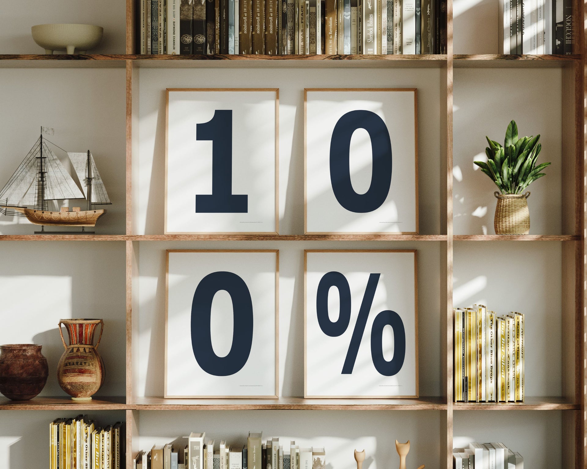 Four framed number and percent sign art prints spelling out 100% on a boho bookshelf.