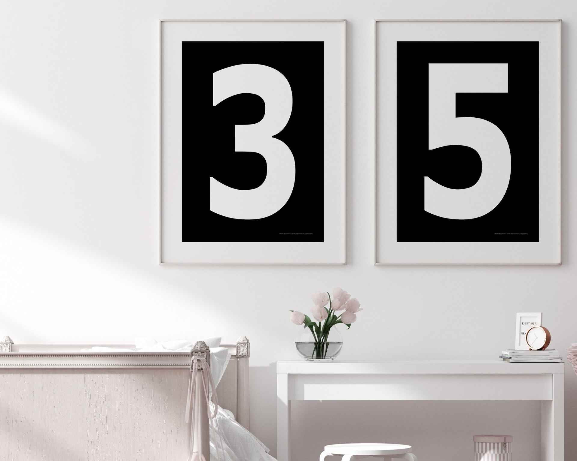 Two framed black and white number art prints showing a jersey number hanging above bed and desk.