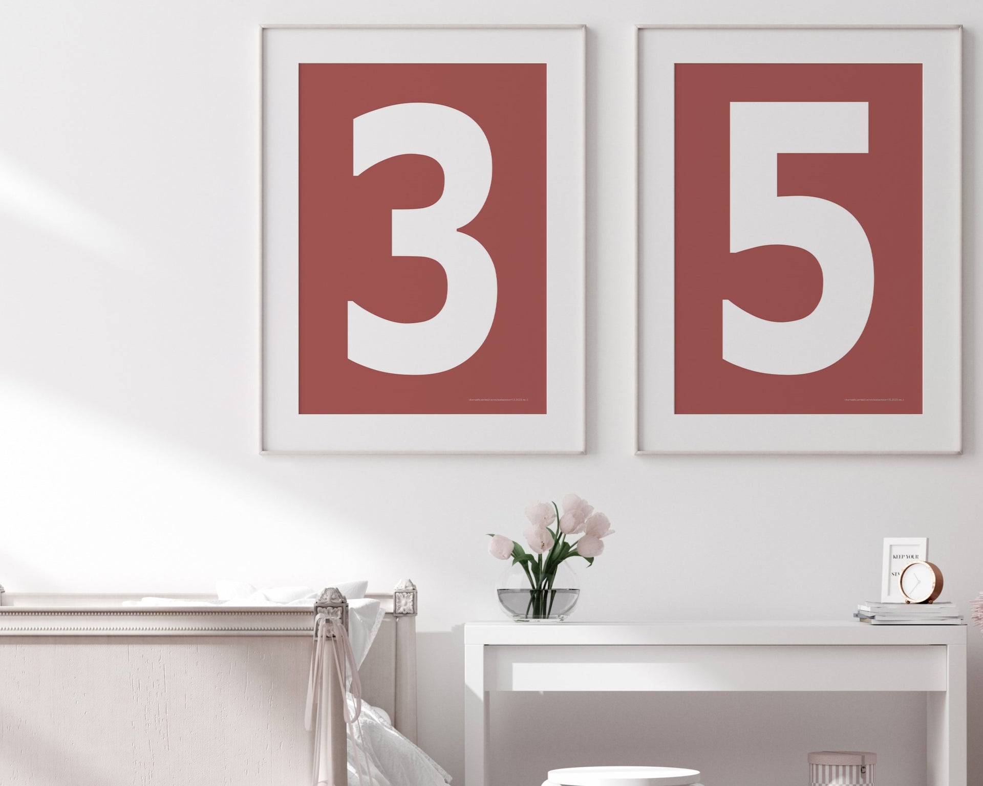 Two framed Nantucket red and white number art prints showing a jersey number hanging above bed and desk.