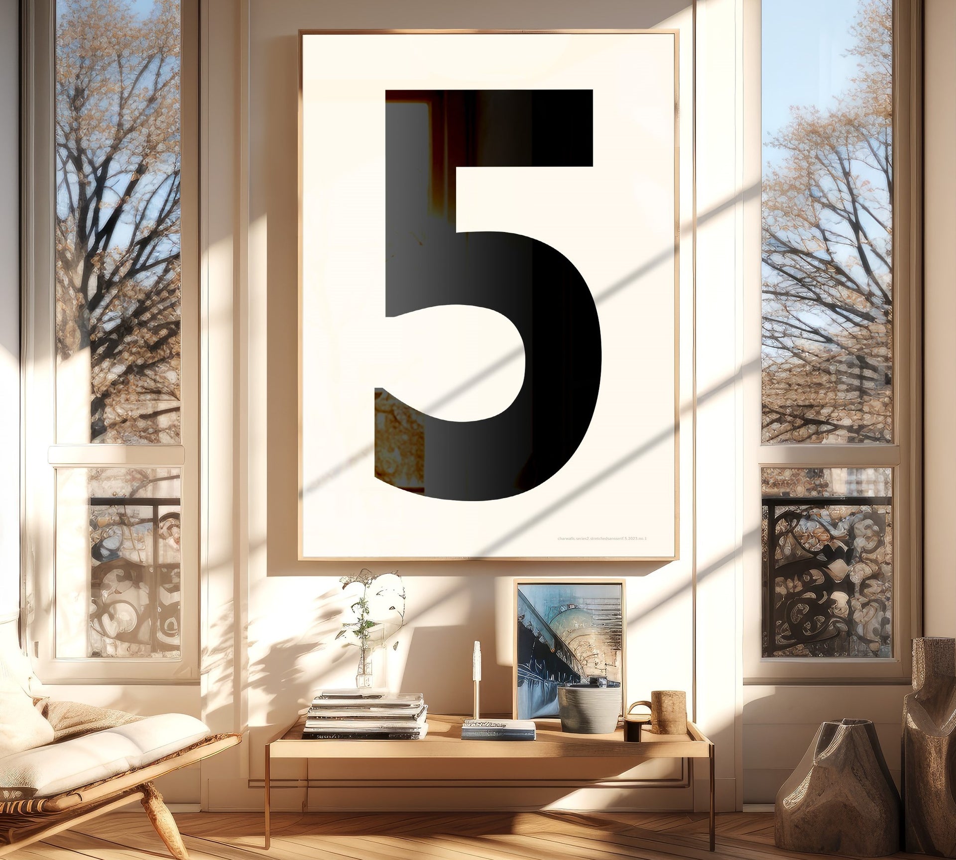 Oversized framed black and white number art print featuring the number 5 in a modern living room.