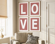 Four framed Nantucket red and white letter art prints spelling out LOVE hanging on wall in living room.