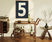 Framed number five art print hanging above a mid century bar cart.