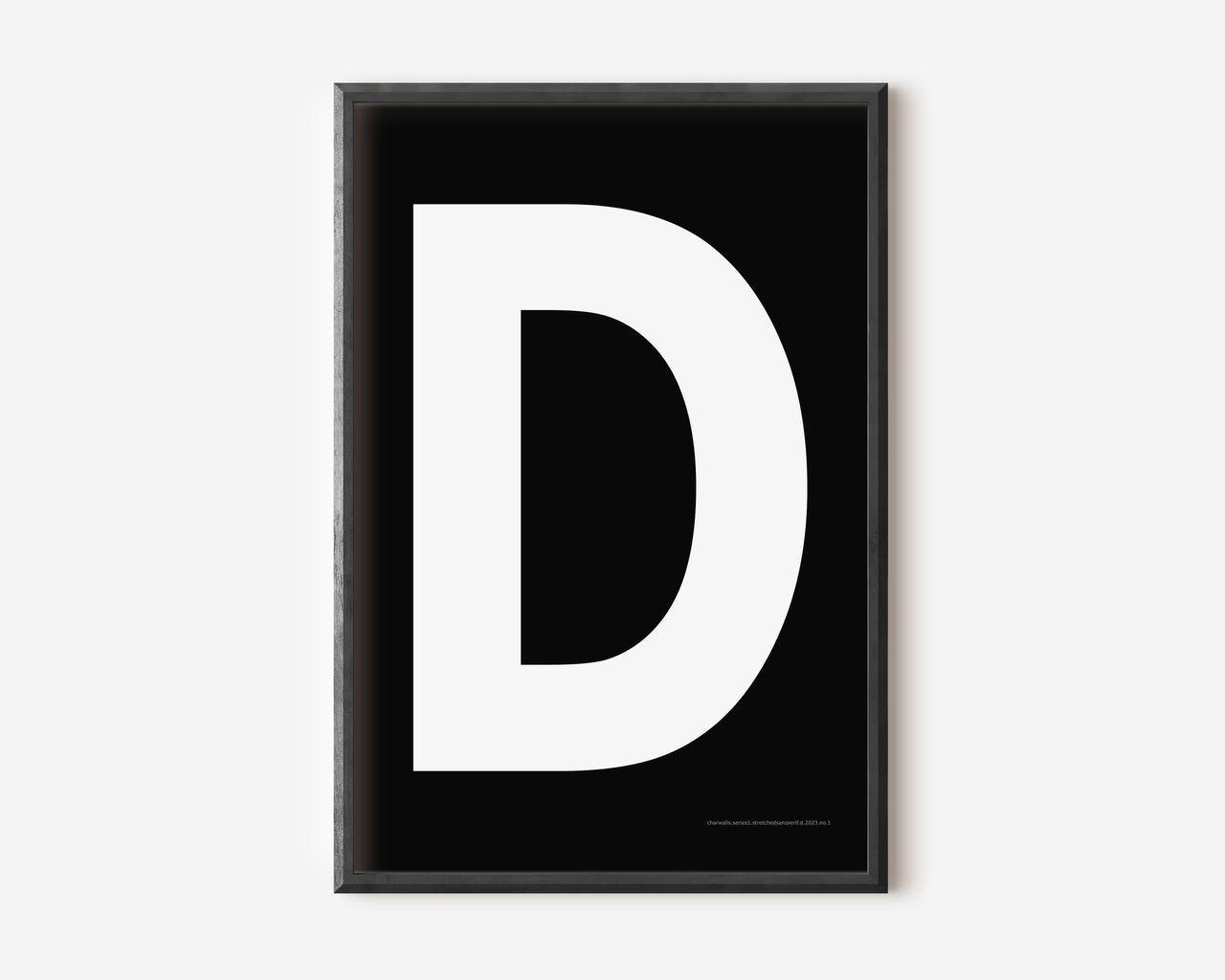 Modern art print with an uppercase white letter D on a black background.