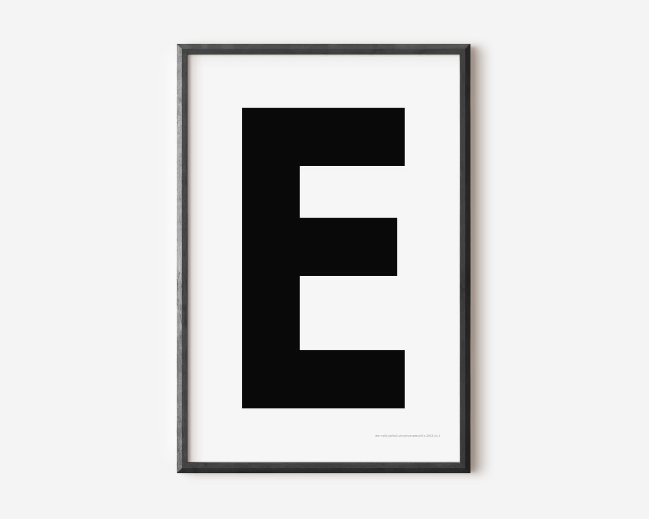 Modern art print with an uppercase black letter E on a white background.