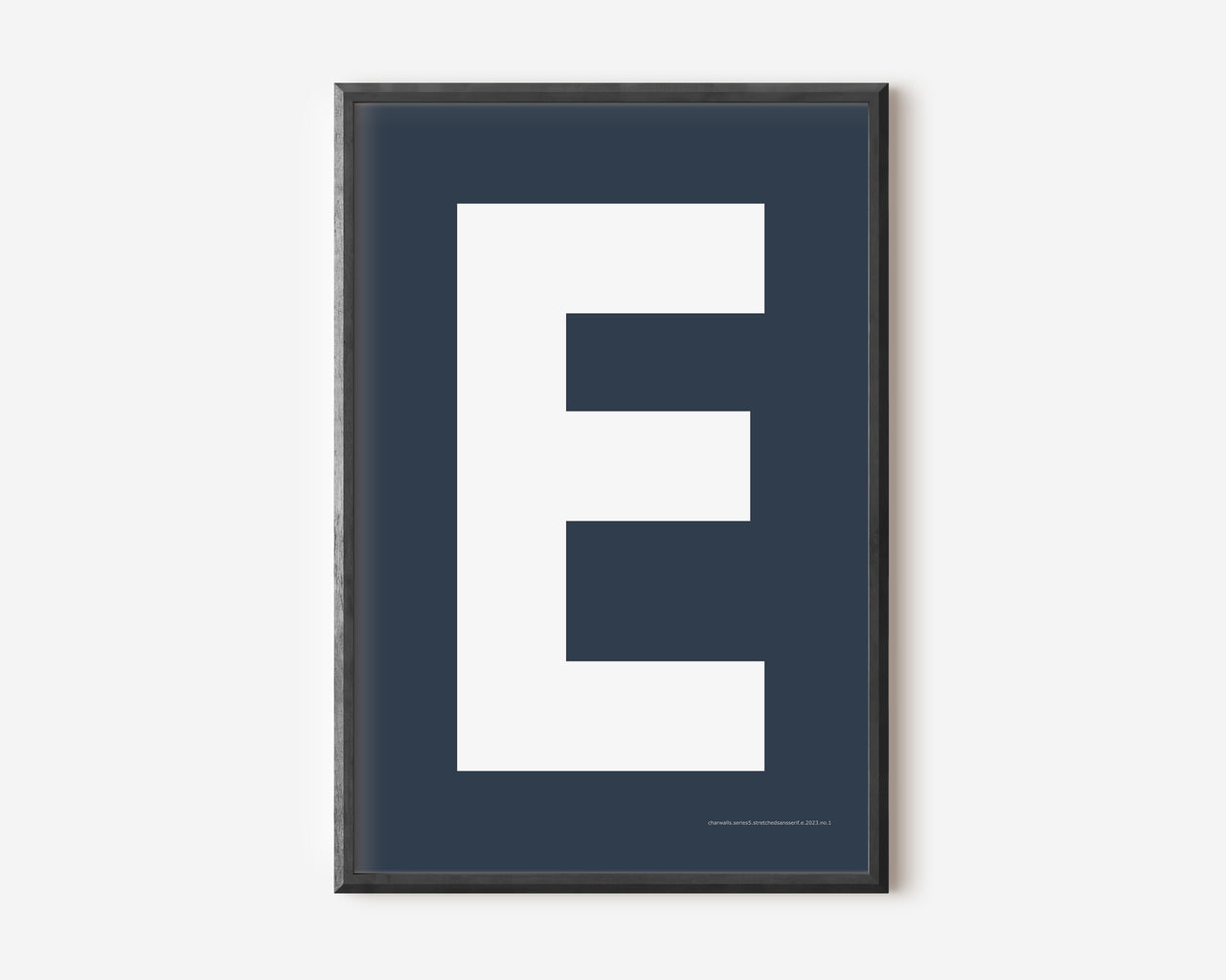 Modern art print with an uppercase white letter E on a navy blue background.