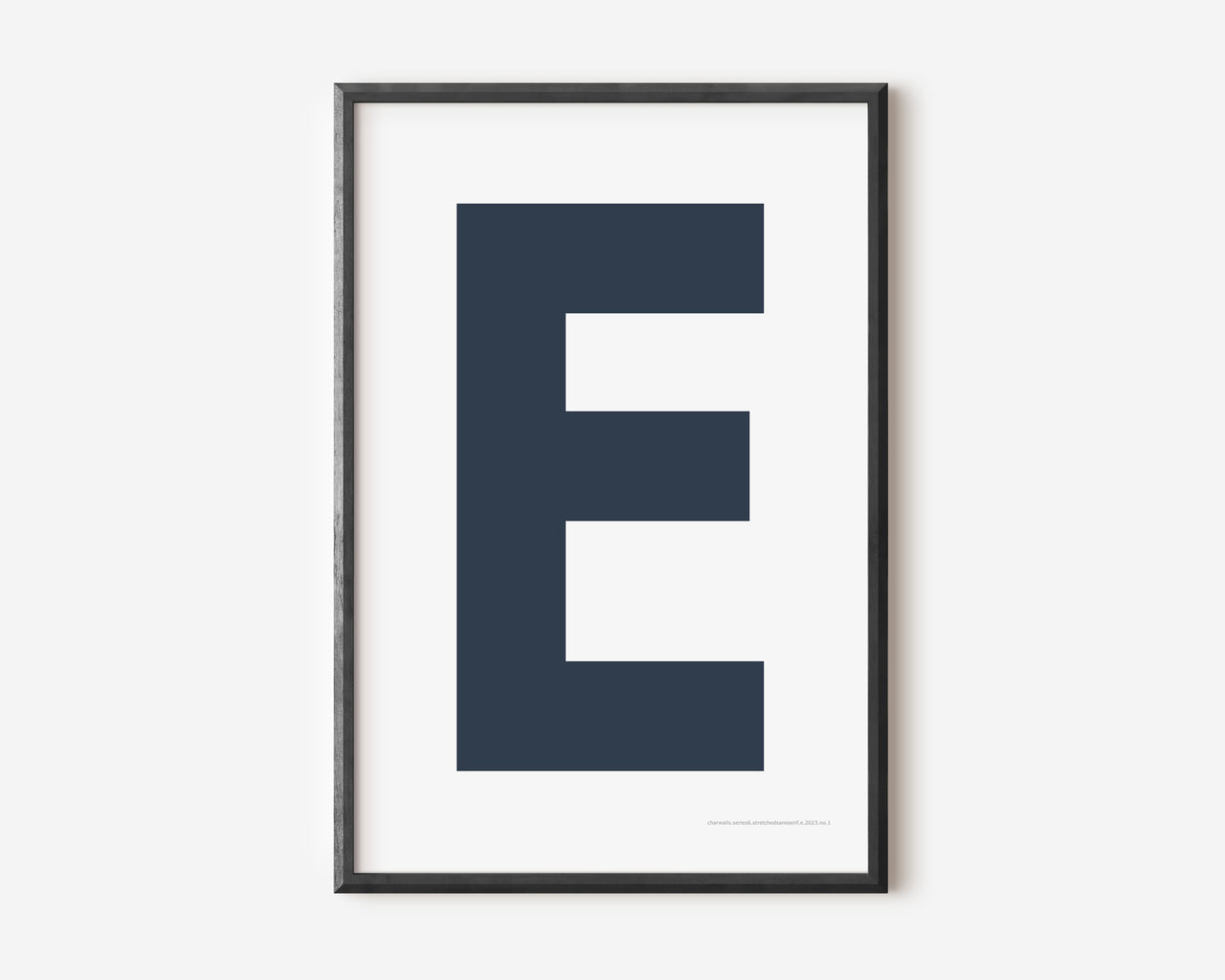 Modern art print with an uppercase navy blue letter E on a white background.