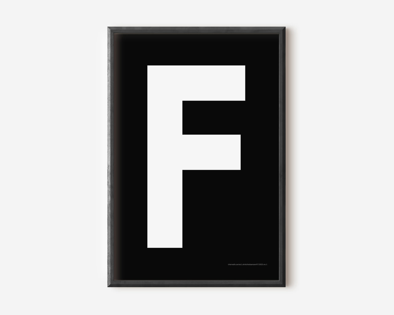 Modern art print with an uppercase white letter F on a black background.