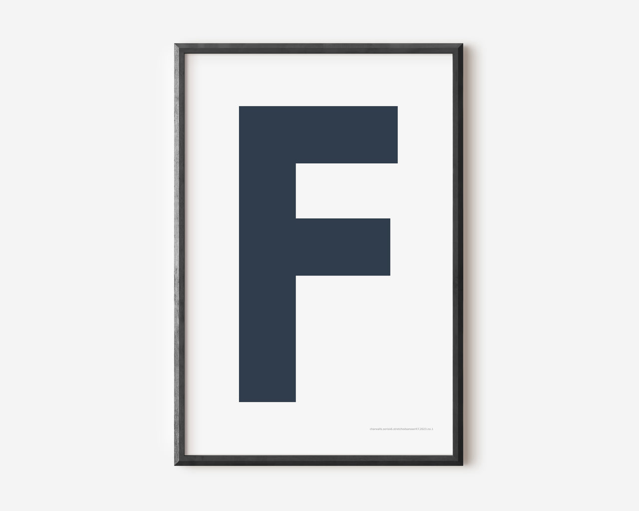 Modern art print with an uppercase navy blue letter F on a white background.