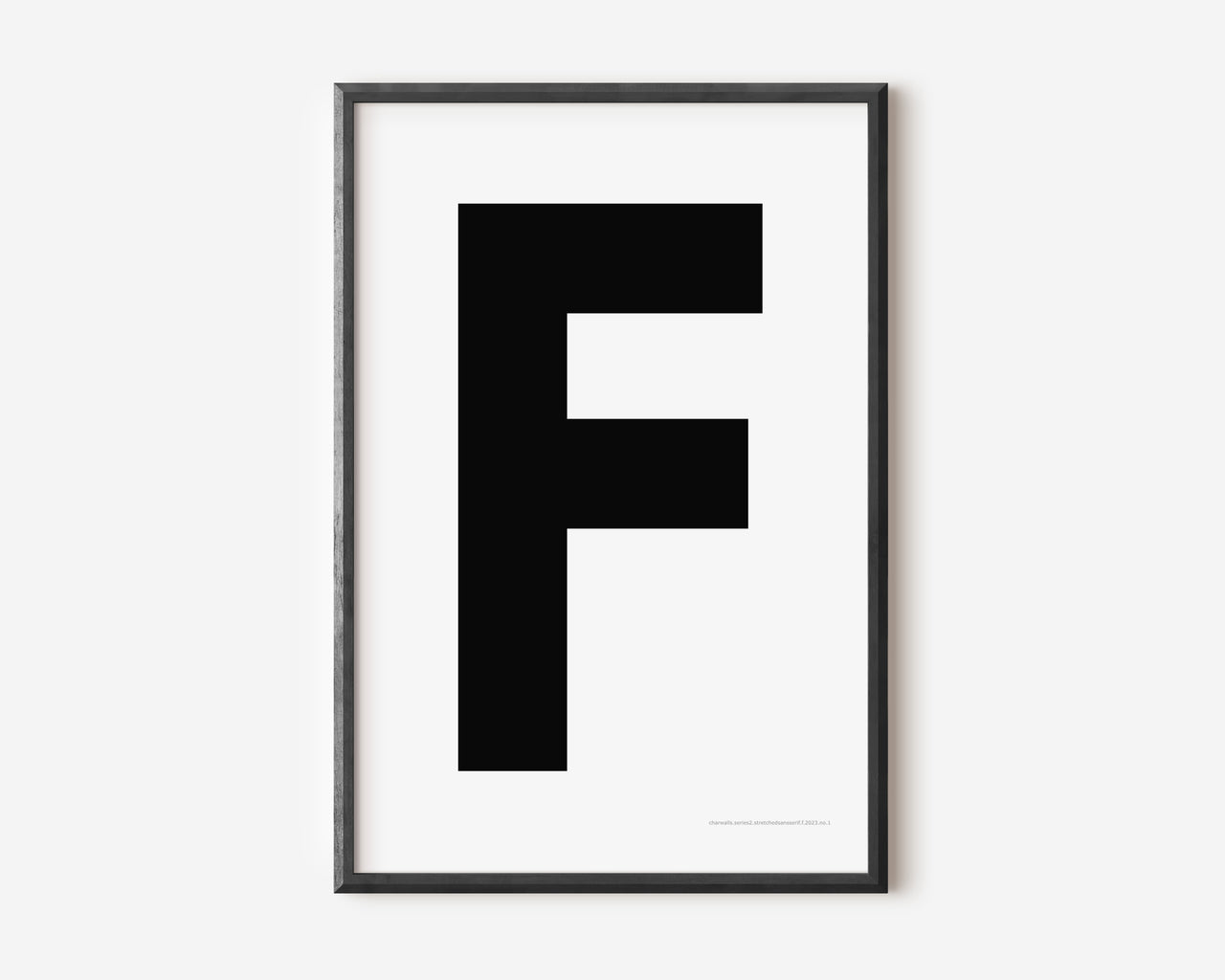 Modern art print with an uppercase black letter F on a white background.