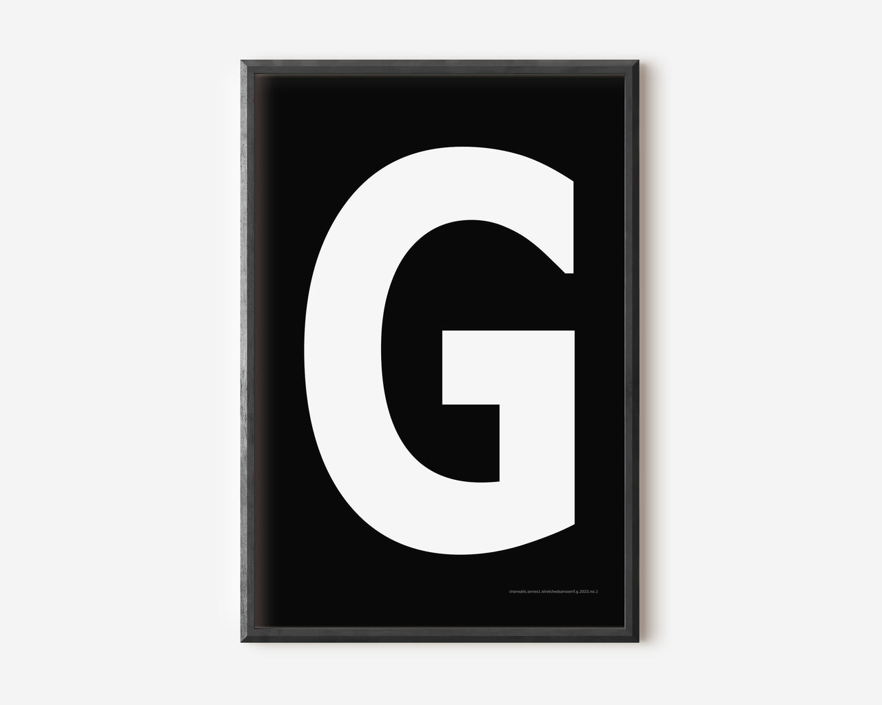 Modern art print with an uppercase white letter G on a black background.