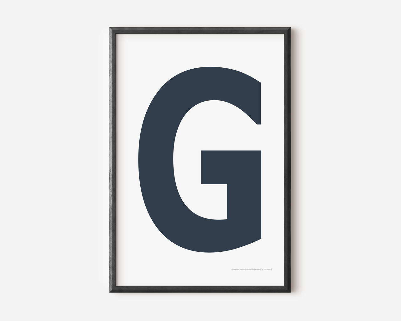 Modern art print with an uppercase navy blue letter G on a white background.