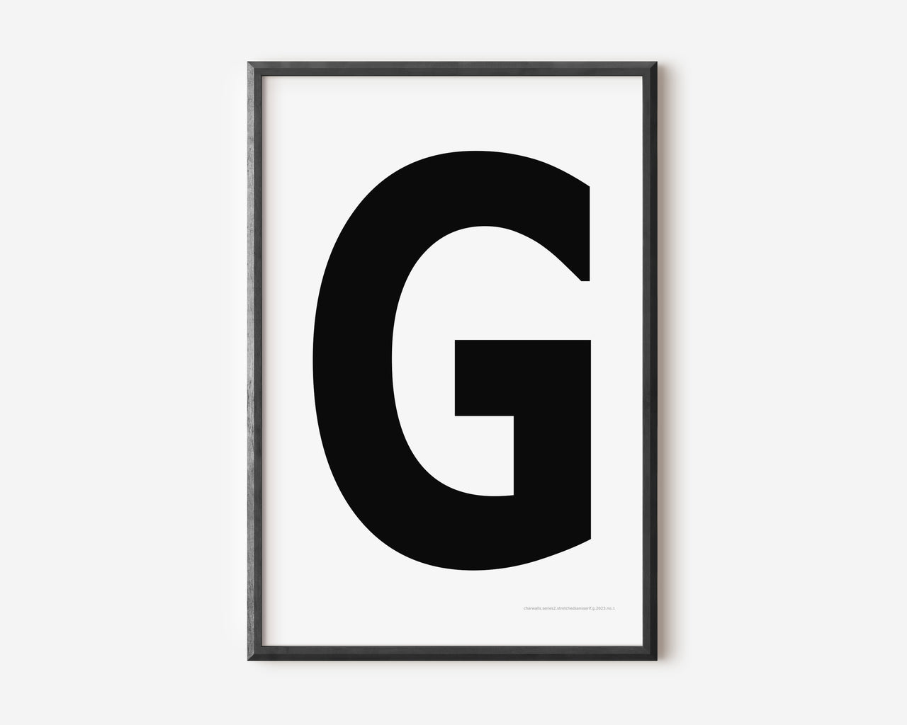 Modern art print with an uppercase black letter G on a white background.