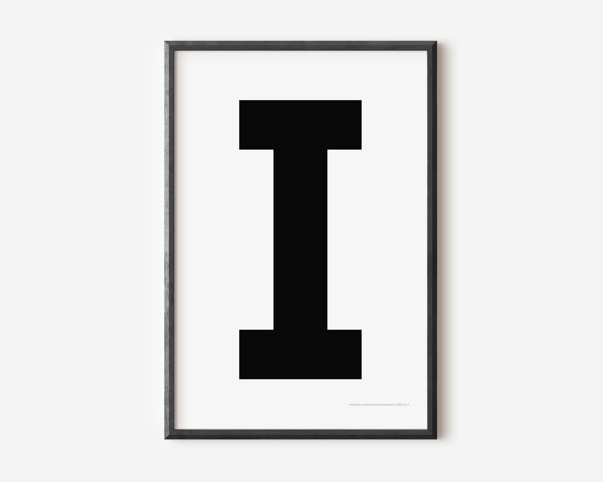 Modern art print with an uppercase black letter I on a white background.