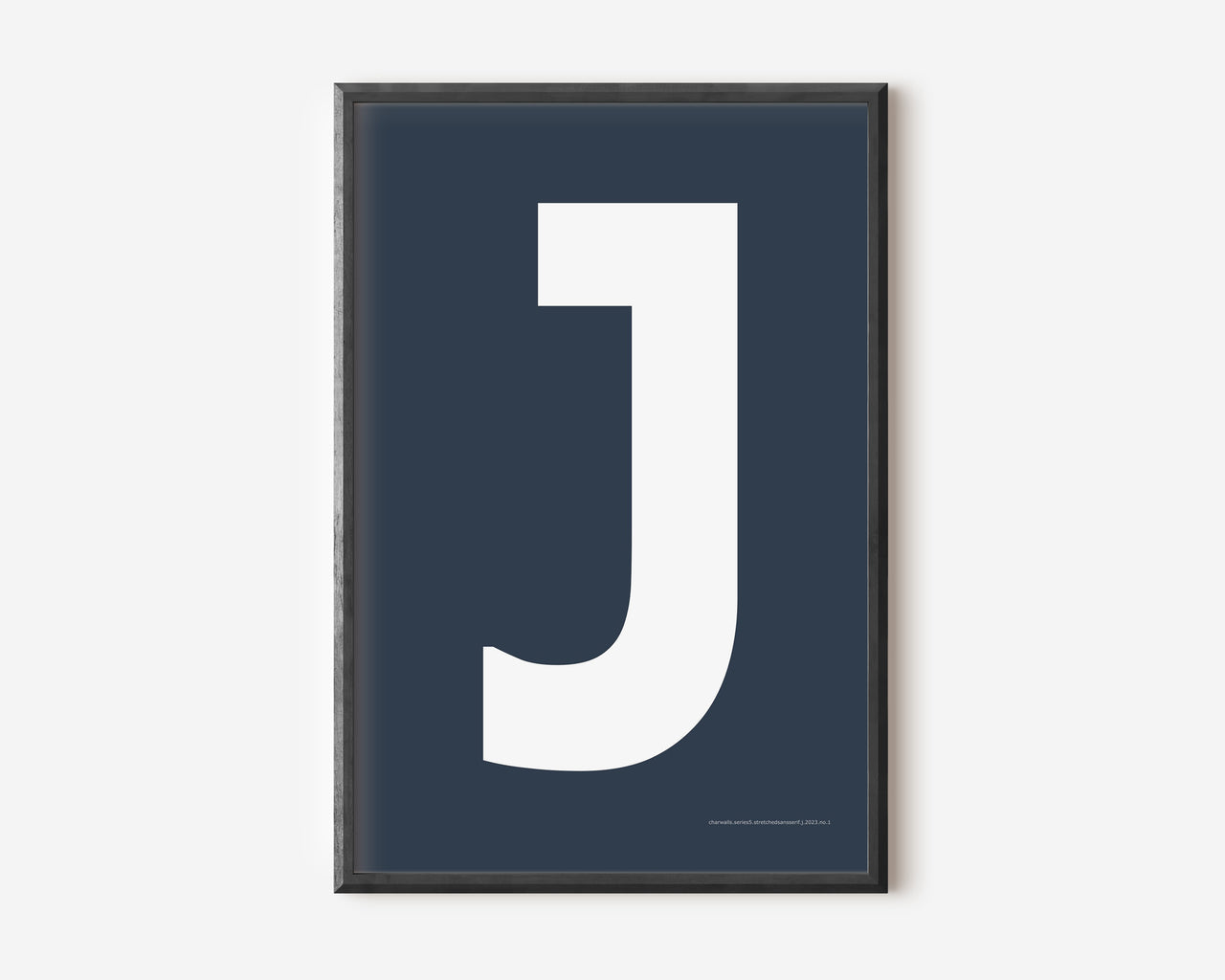 Modern art print with an uppercase white letter J on a navy blue background.