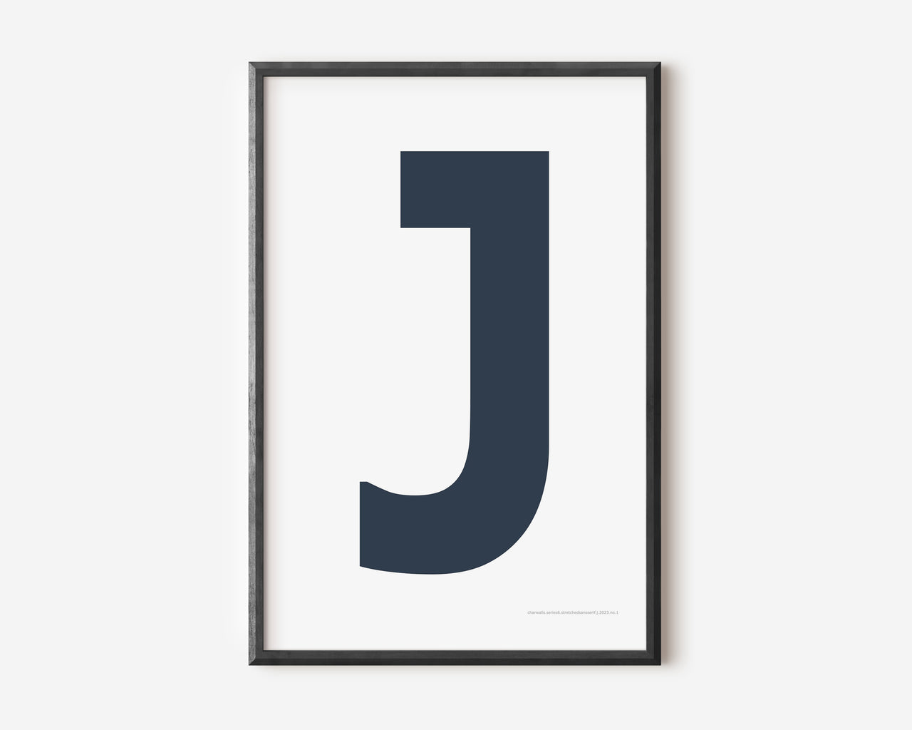 Modern art print with an uppercase navy blue letter J on a white background.