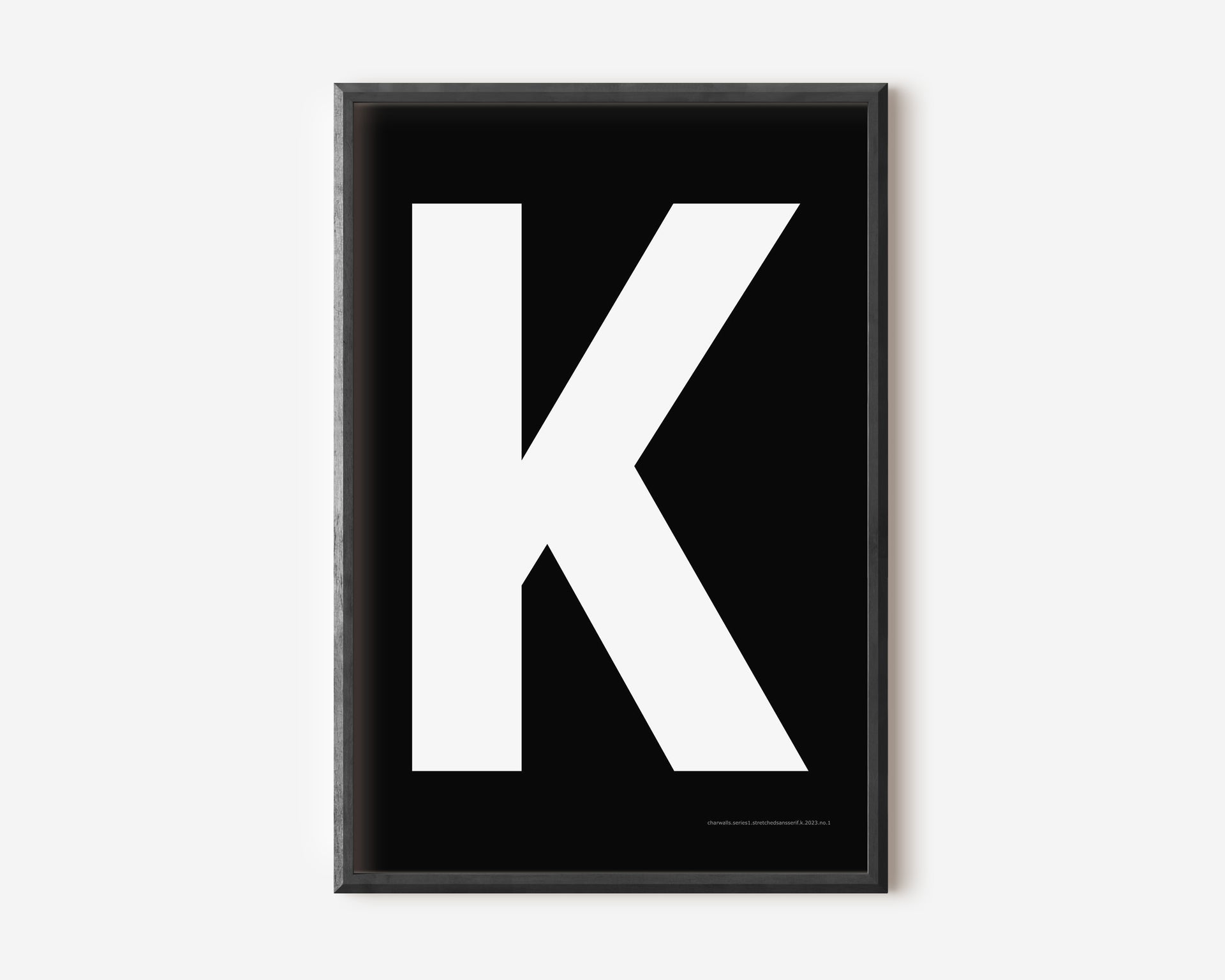 Modern art print with an uppercase white letter K on a black background.