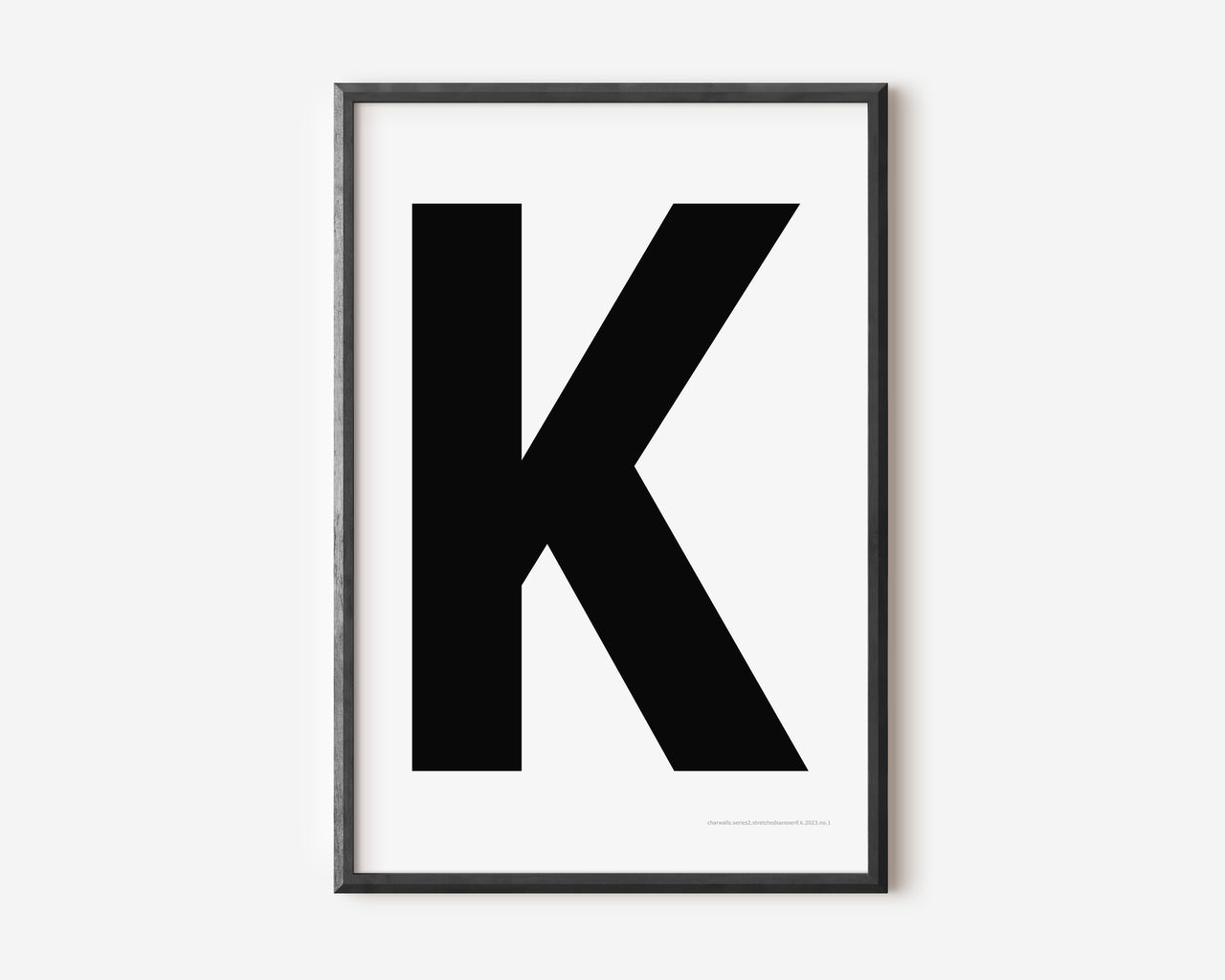 Modern art print with an uppercase black letter K on a white background.