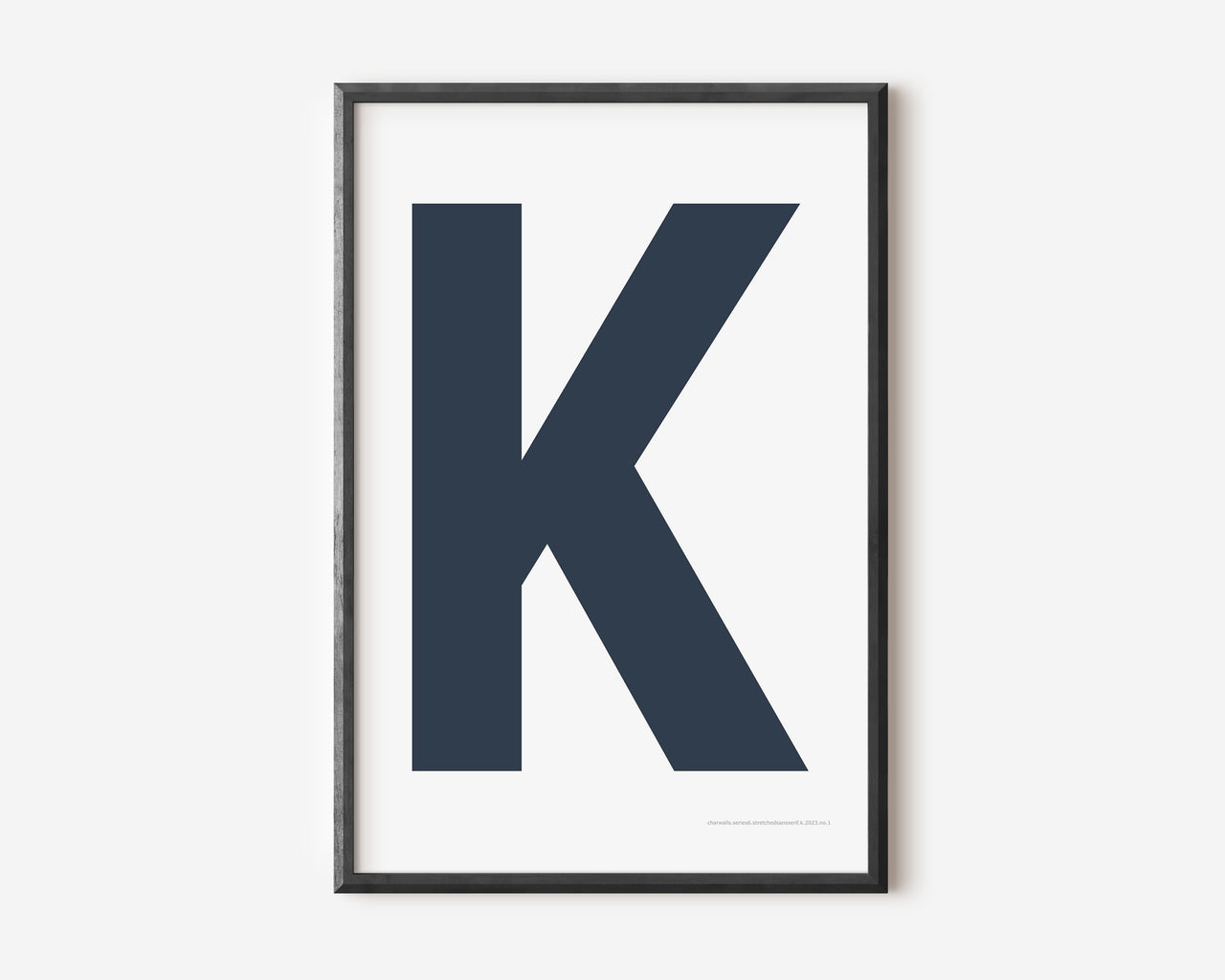 Modern art print with an uppercase navy blue letter K on a white background.