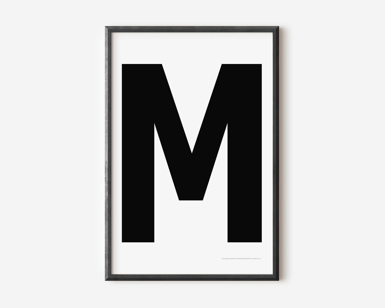 Modern art print with an uppercase black letter M on a white background.