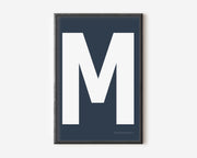 Modern art print with an uppercase white letter M on a navy blue background.