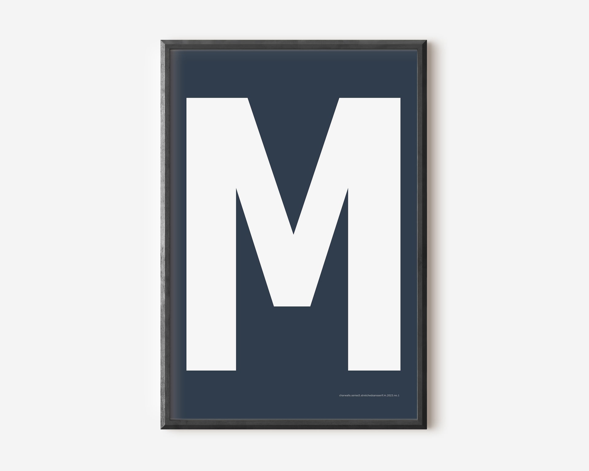 Modern art print with an uppercase white letter M on a navy blue background.