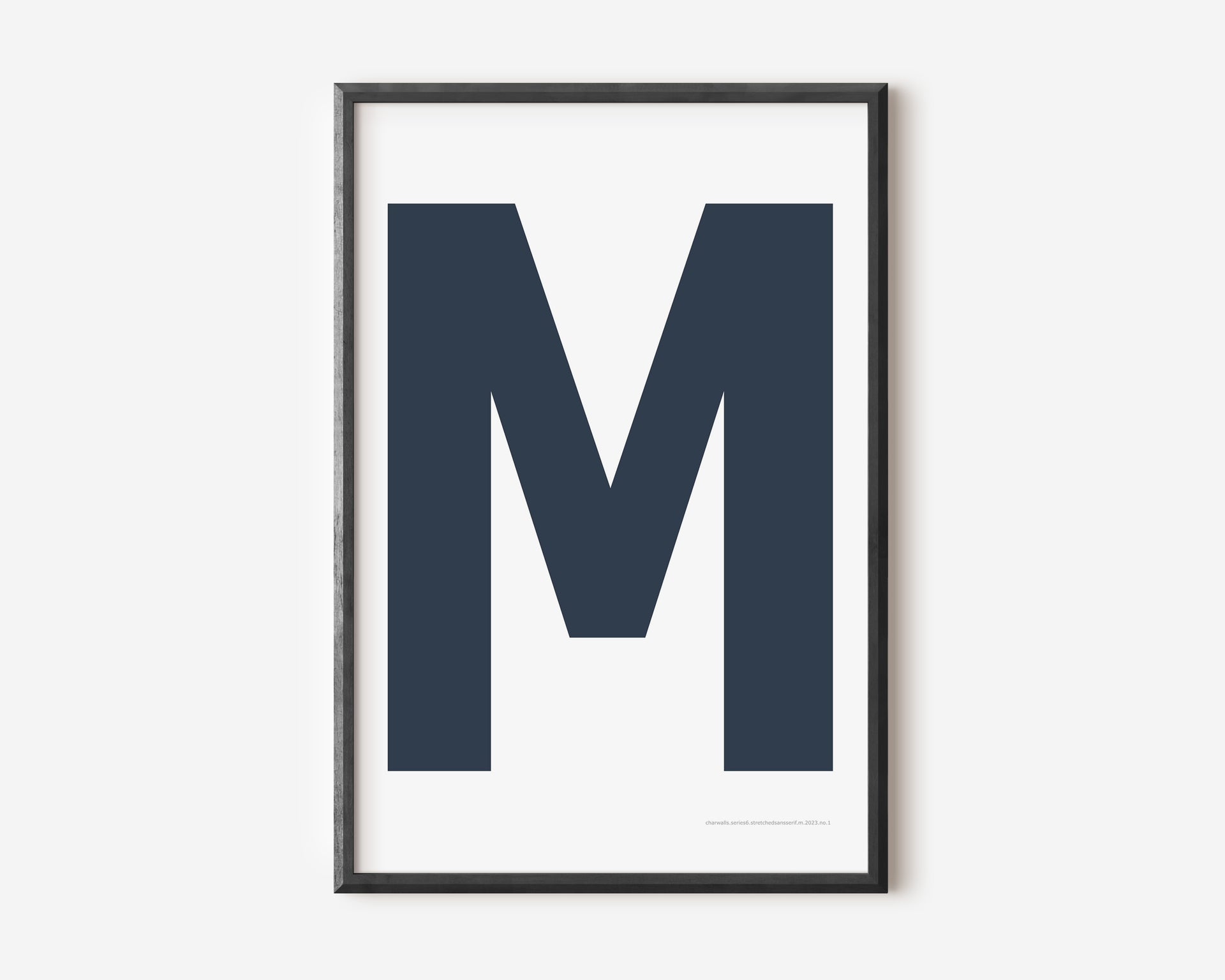 Modern art print with an uppercase navy blue letter M on a white background.