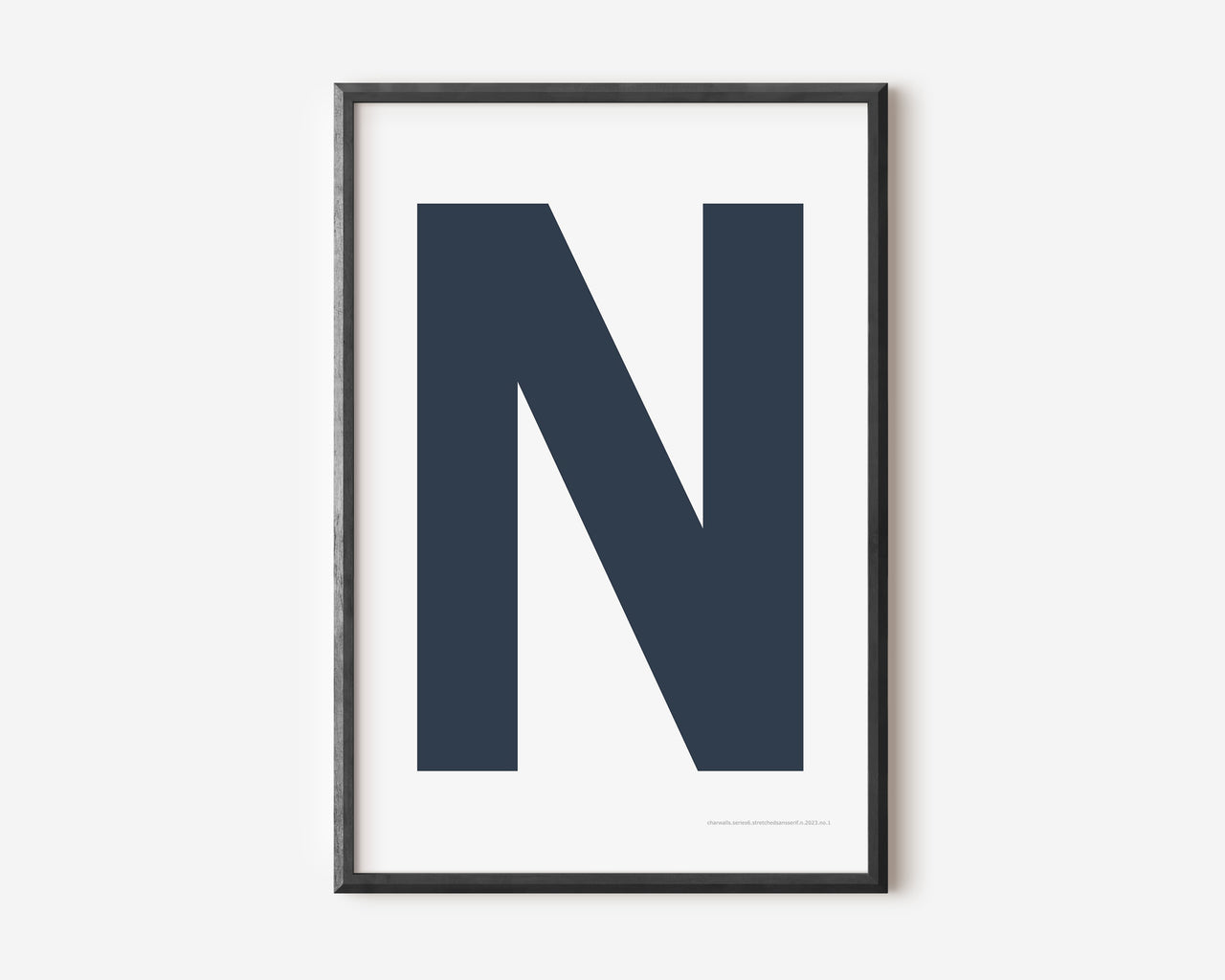 Modern art print with an uppercase navy blue letter N on a white background.