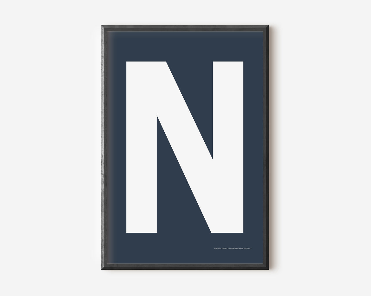 Modern art print with an uppercase white letter N on a navy blue background.