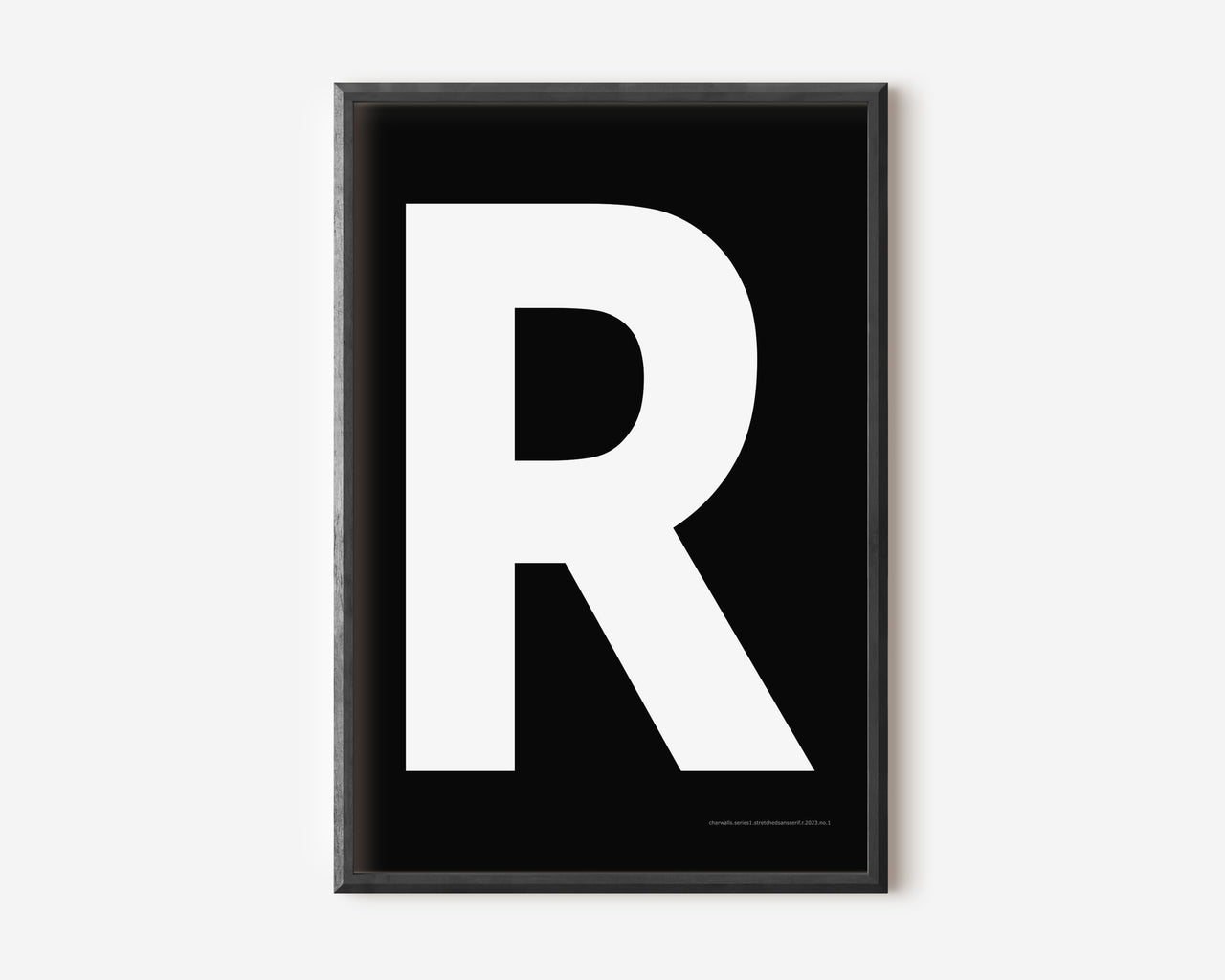 Modern art print with an uppercase white letter R on a black background.