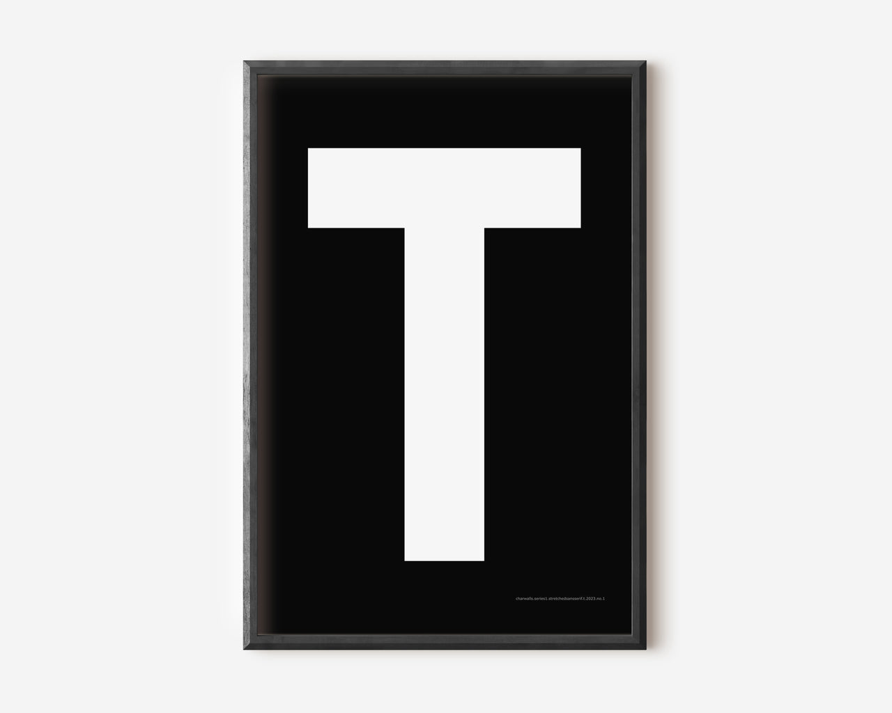 Modern art print with an uppercase white letter T on a black background.