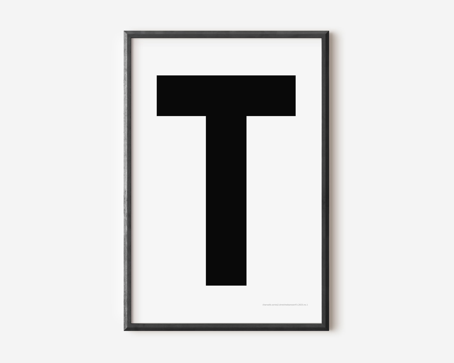 Modern art print with an uppercase black letter T on a white background.