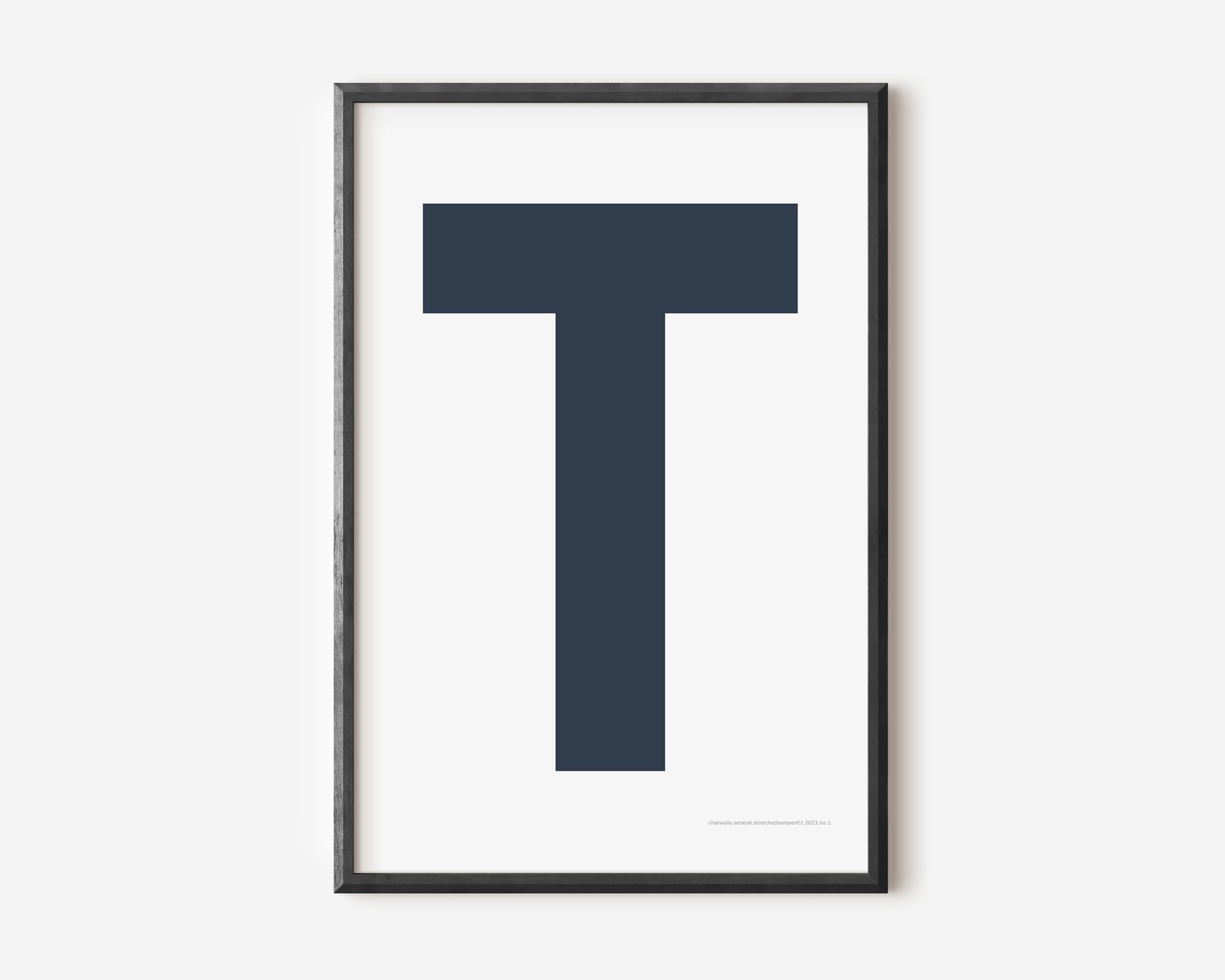 Modern art print with an uppercase navy blue letter T on a white background.