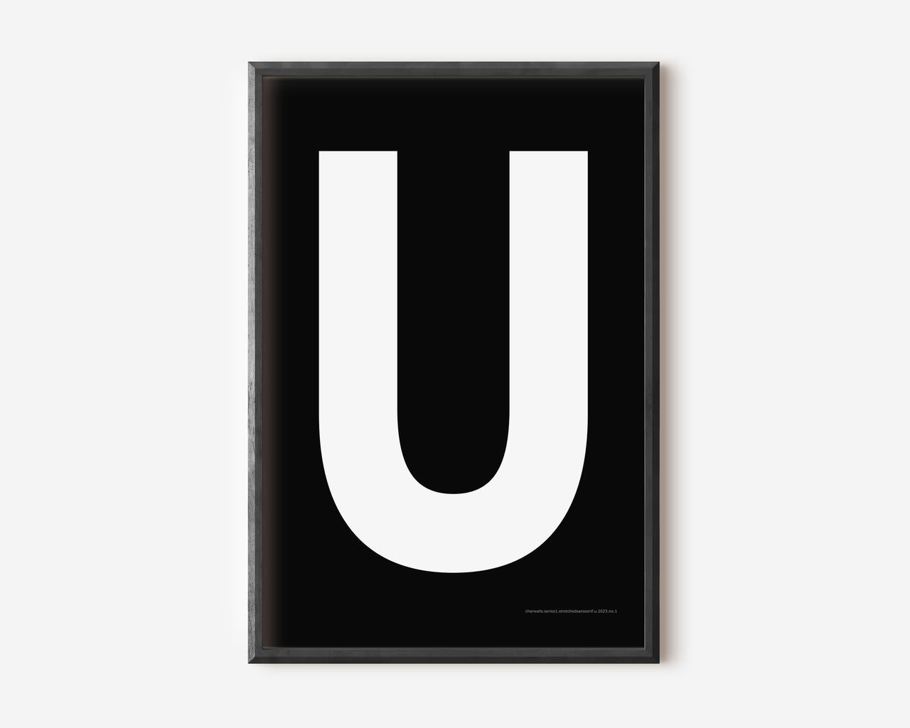 Modern art print with an uppercase white letter U on a black background.
