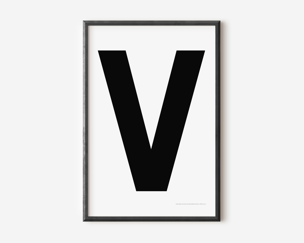 Modern art print with an uppercase black letter V on a white background.