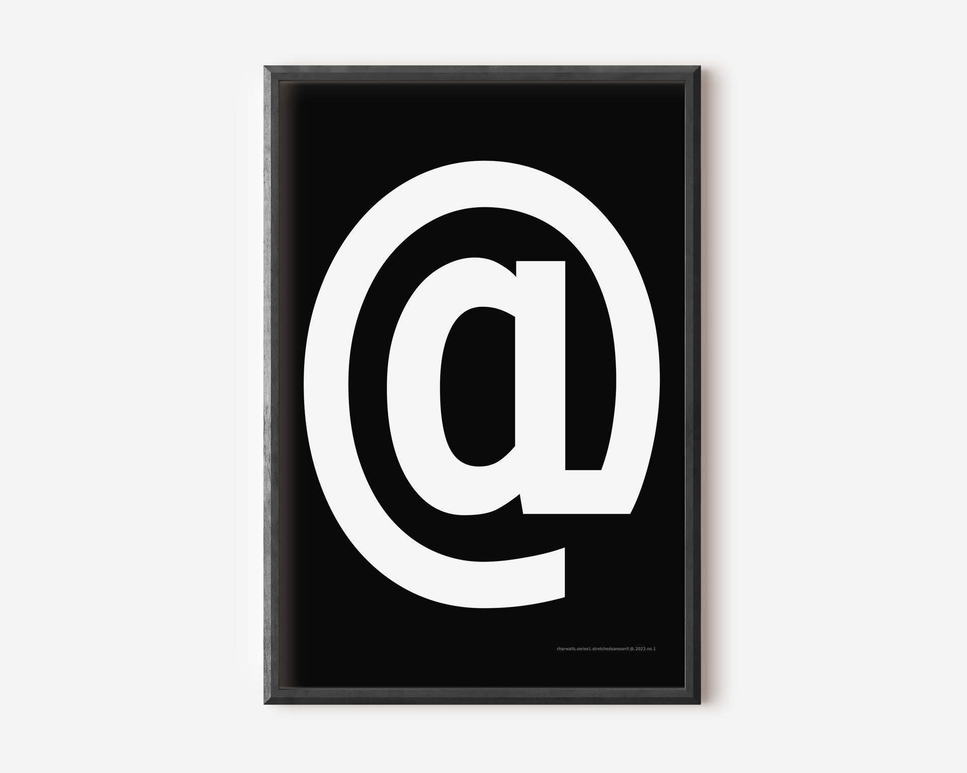 Modern symbol art print with a white at sign on a black background.