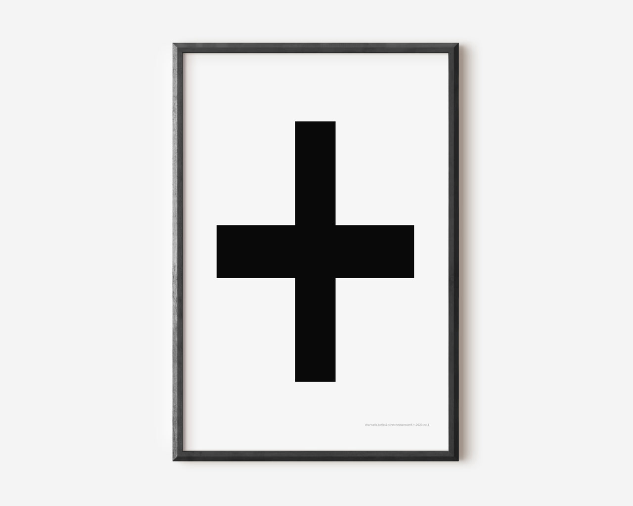 Modern symbol art print with a black plus sign on a white background.