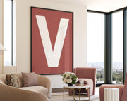 Oversized framed Nantucket red and white letter V art print hanging in a modern living room.