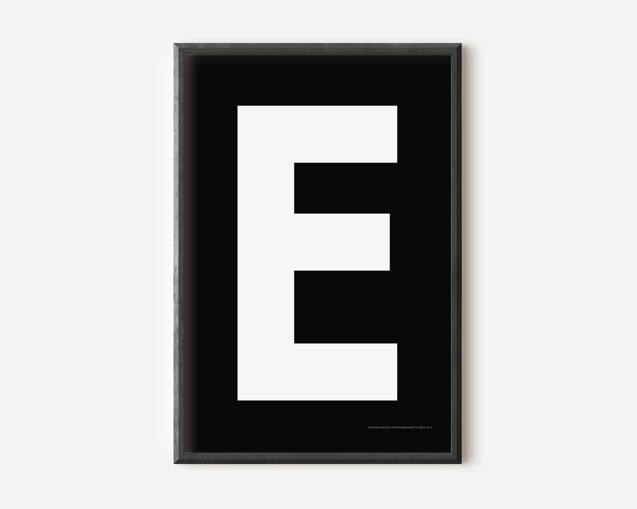 Modern art print with an uppercase white letter E on a black background.