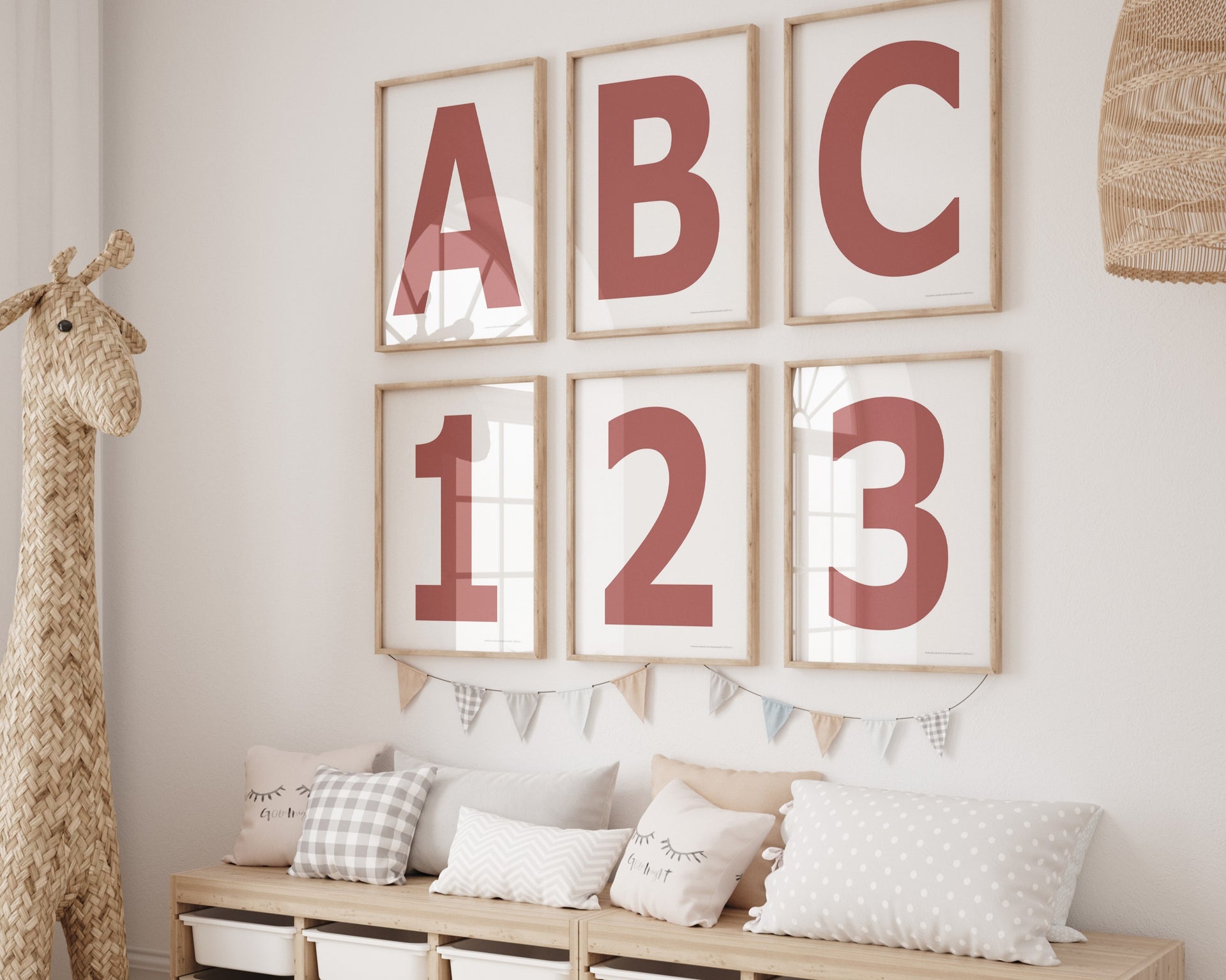 Six framed Nantucket red and white letter and number art prints spelling out ABC123 hanging on a wall in a nursery or playroom