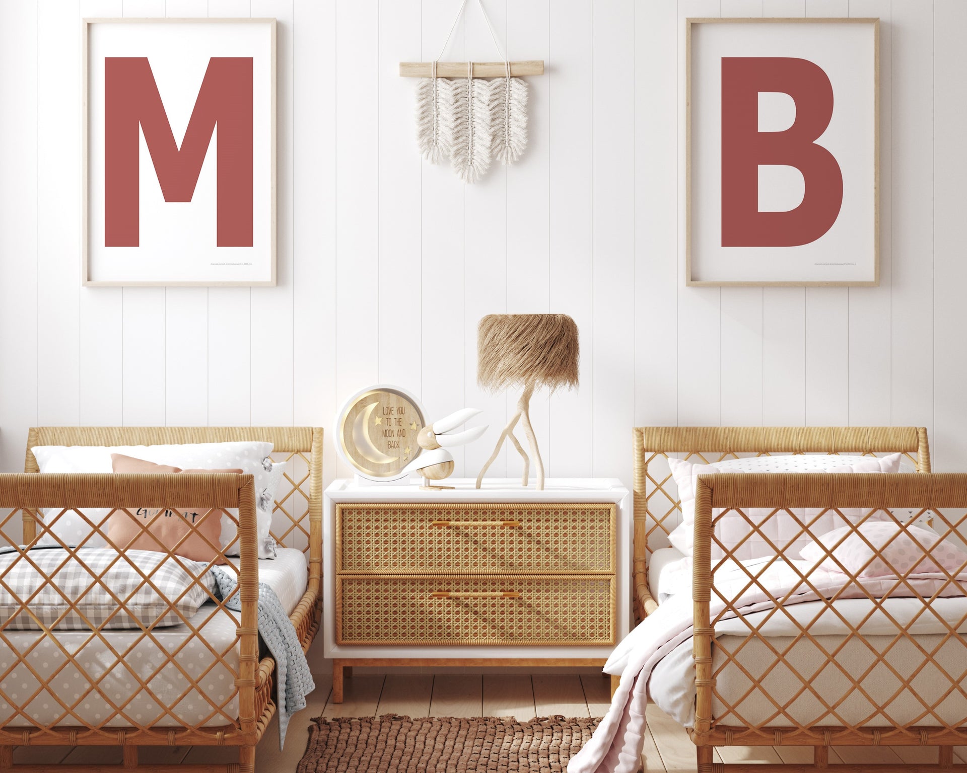 Two framed Nantucket red and white letter art prints showing initials above twin beds.