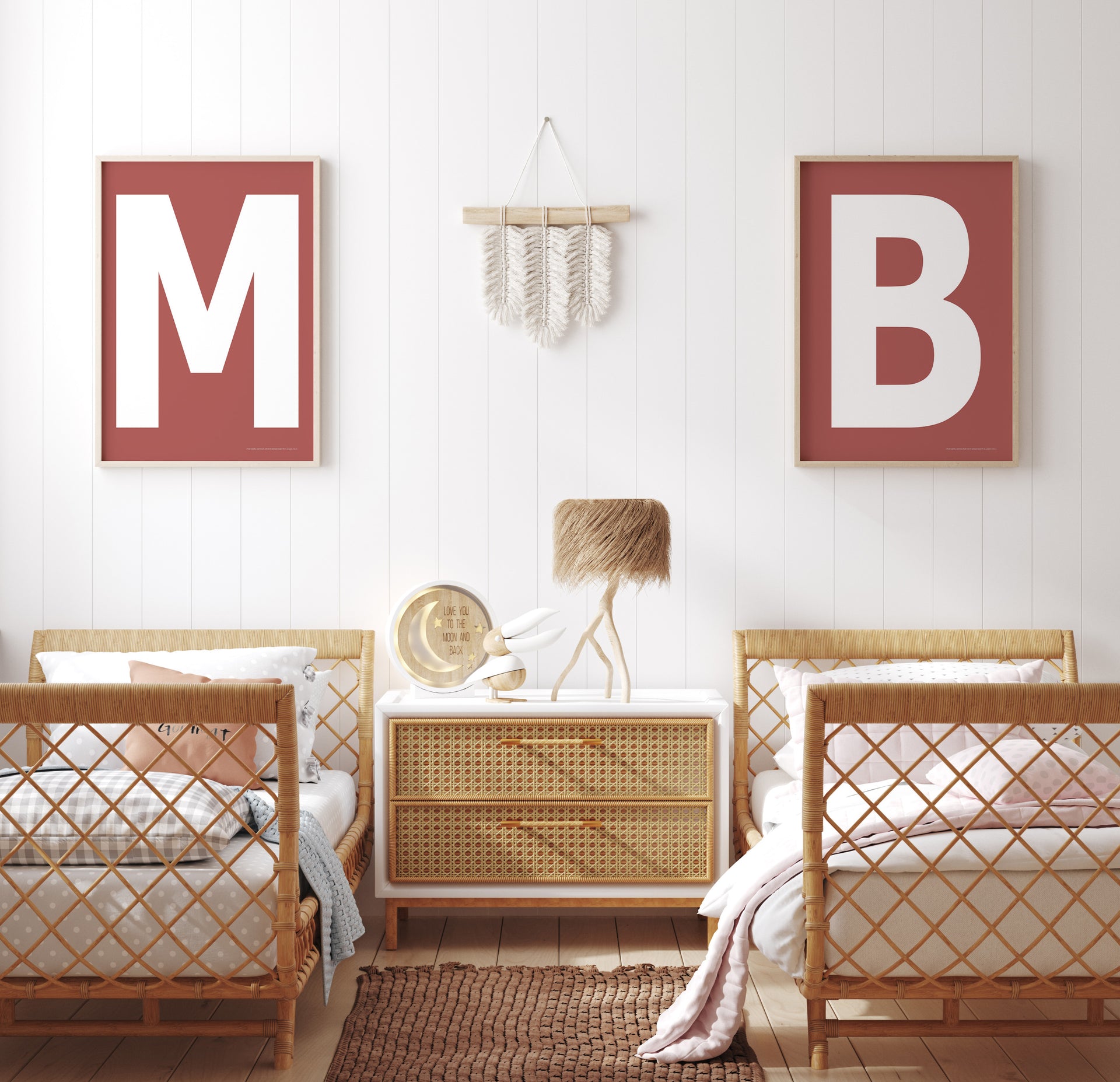 Two framed Nantucket red and white letter art prints showing initials above twin beds.