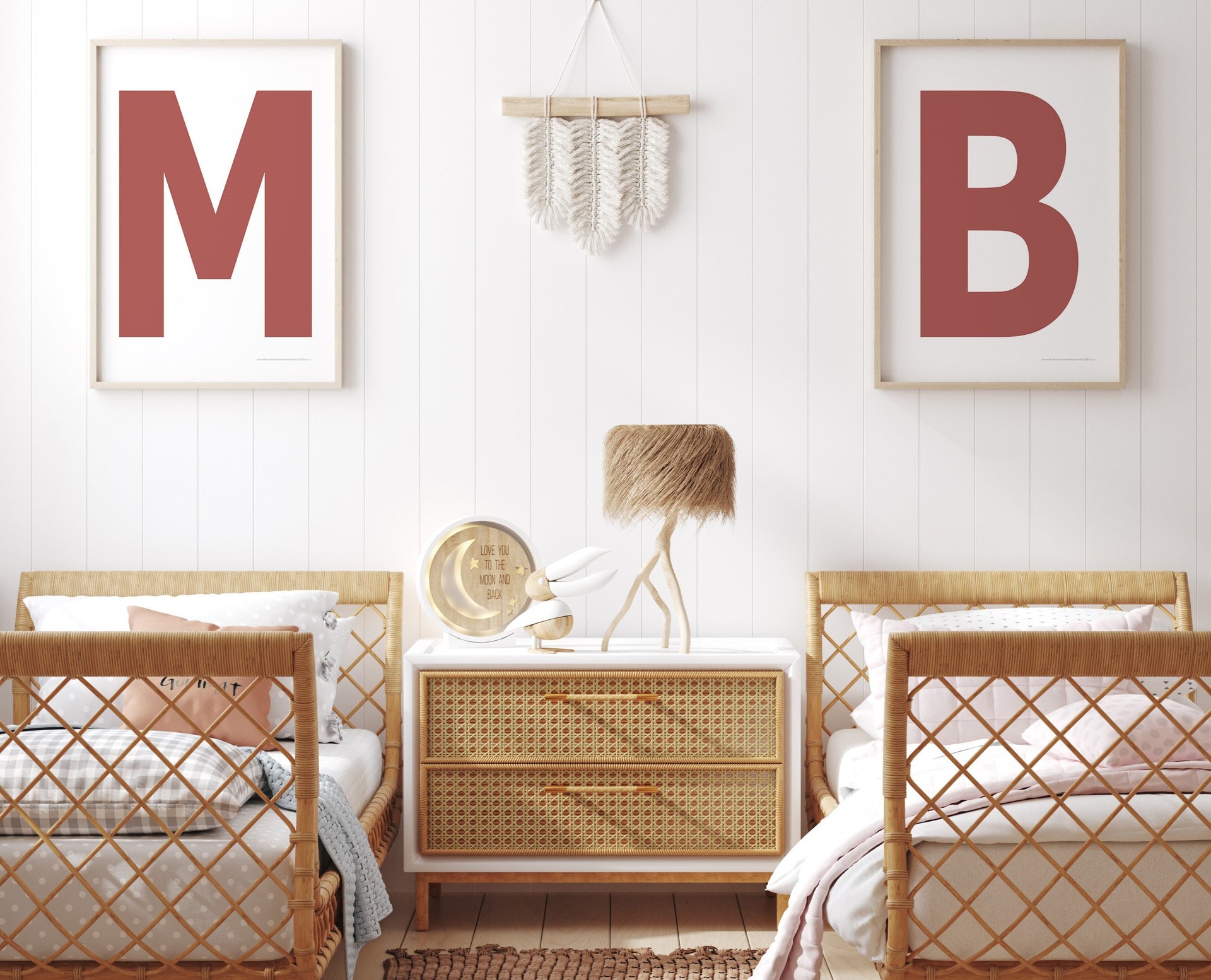 Two framed Nantucket red and white letter art prints showing initials above twin beds.