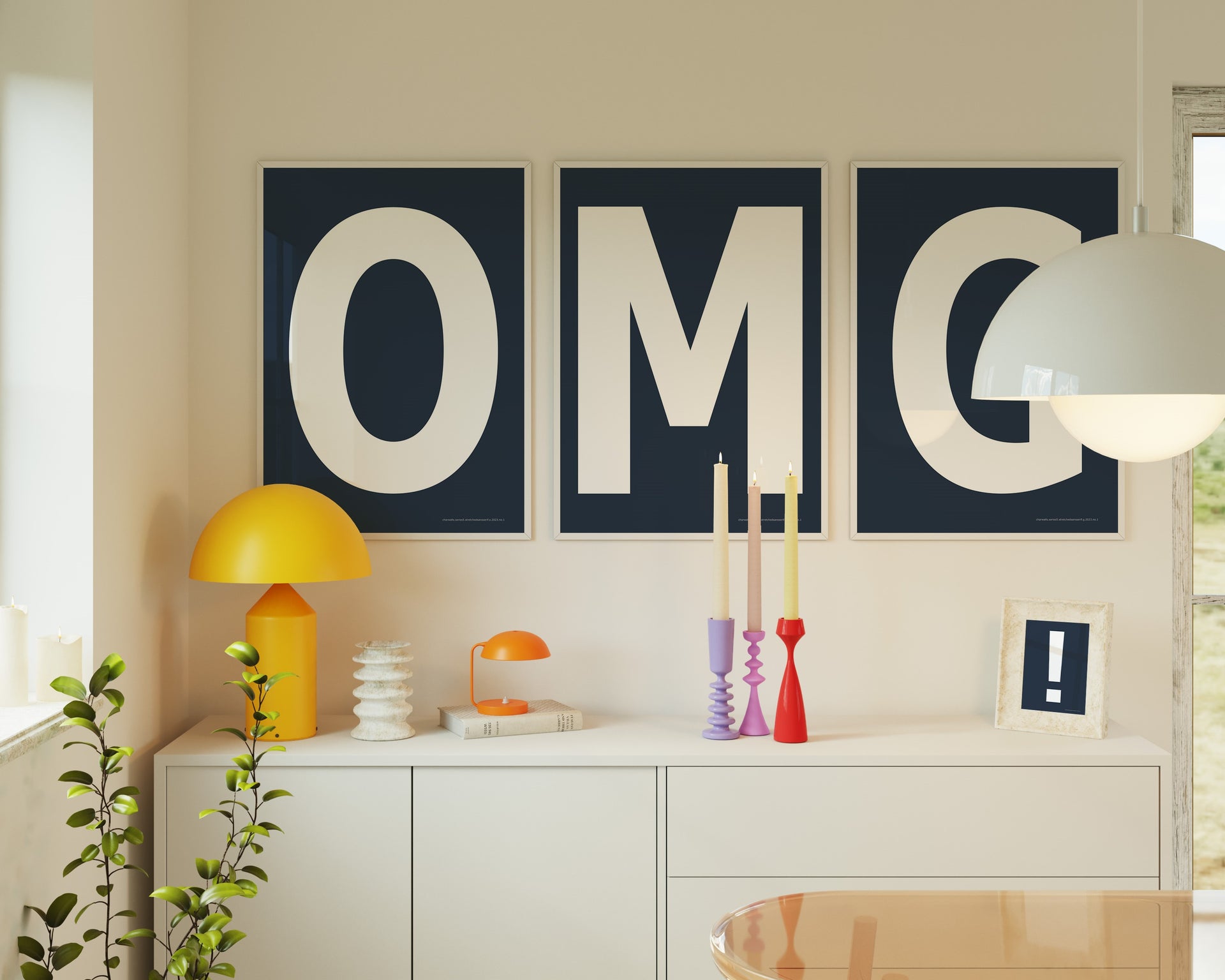 Three framed navy blue and white letter art prints spelling out OMG hanging above a credenza