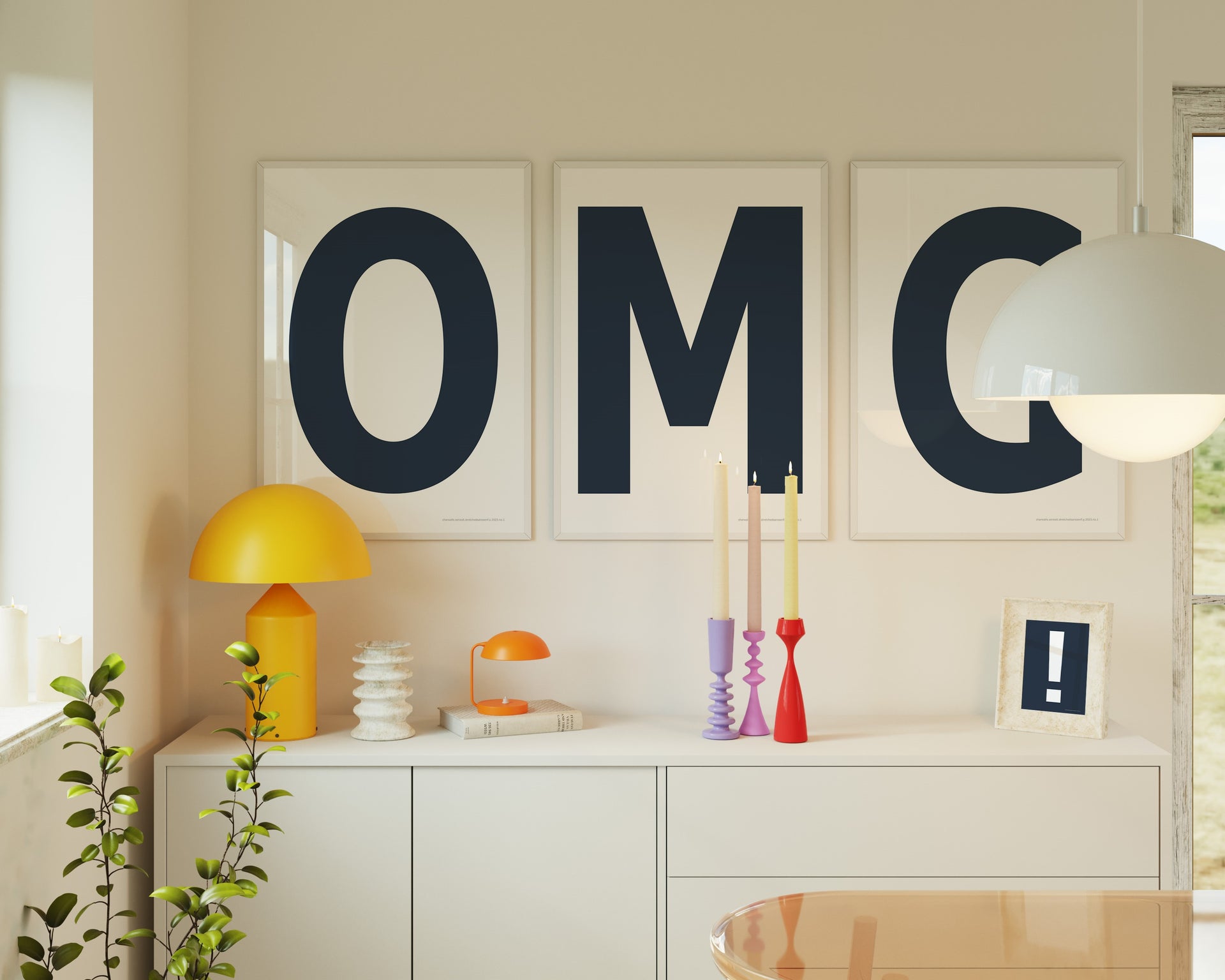 Three framed white and navy blue letter art prints spelling out OMG hanging above a credenza.